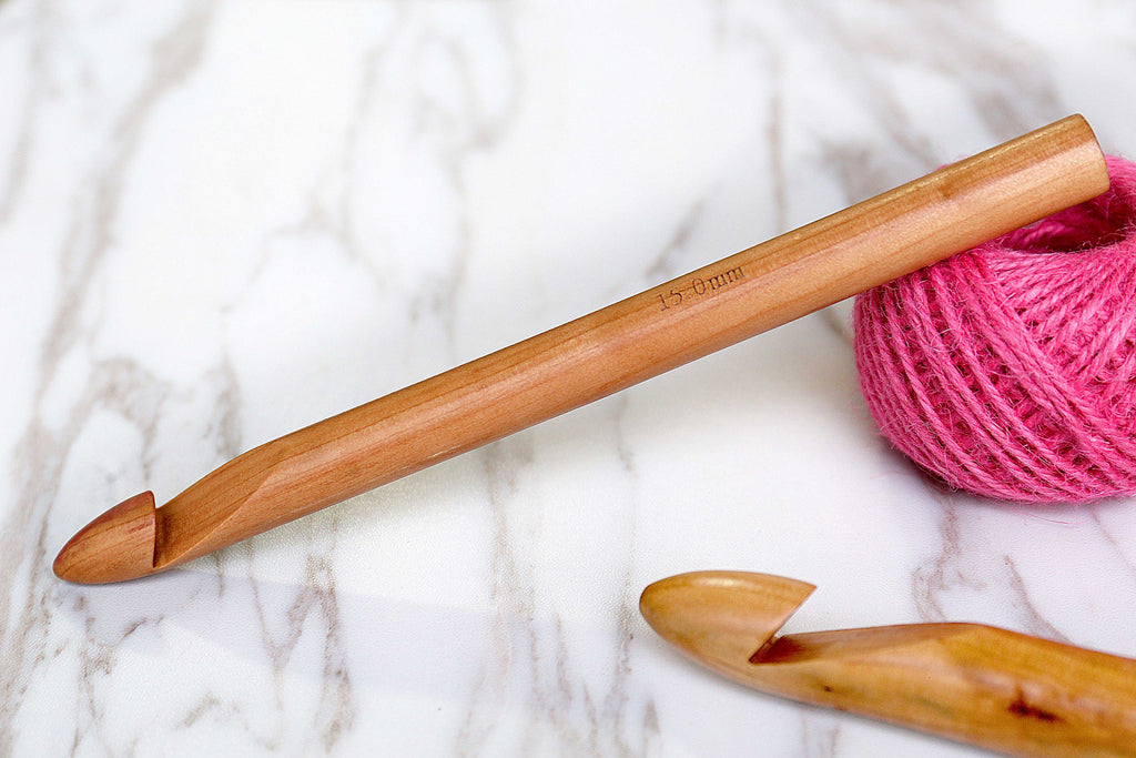 Three giant cakes of super-bulky yarn, one 25mm crochet hook and